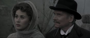 Movie still from “Dracula” (1979), directed by John Badham – A man and a woman wearing a black hat; Close Up shot, Over the shoulder angle