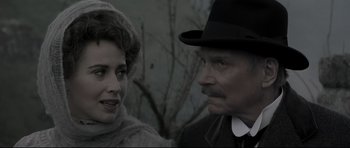 Movie still from “Dracula” (1979), directed by John Badham – A man and a woman standing next to each other in front of a tree; Close Up shot, Over the shoulder angle