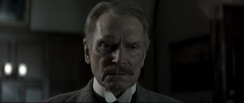 Movie still from “Dracula” (1979), directed by John Badham – An older man with a mustache and a mustache comb; Close Up shot, Low angle