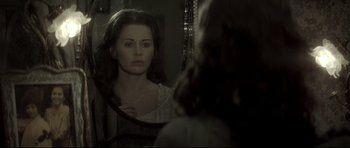 Movie still from “Dracula” (1979), directed by John Badham – A woman looking at herself in the mirror; Close Up shot, Over the shoulder angle