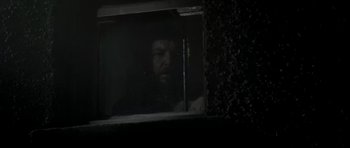 Movie still from “Dracula” (1979), directed by John Badham – A man looking out of a window at night; Medium shot, Low angle