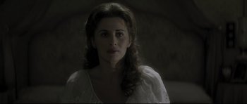 Movie still from “Dracula” (1979), directed by John Badham – A woman in a white dress is looking at the camera; Close Up shot, Over the shoulder angle