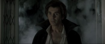 Movie still from “Dracula” (1979), directed by John Badham – A person wearing a black jacket; Close Up shot, Low angle