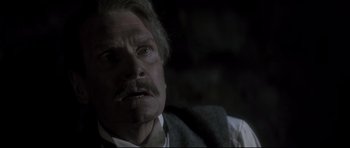 Movie still from “Dracula” (1979), directed by John Badham – An old man with a mustache and a beard looking at the camera; Close Up shot, Low angle