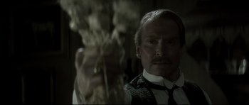 Movie still from “Dracula” (1979), directed by John Badham – A person wearing a suit and tie; Close Up shot, Low angle