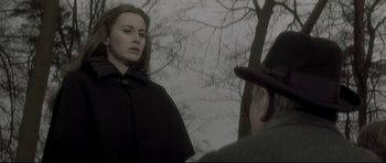 Movie still from “Dracula” (1979), directed by John Badham – A woman wearing a black cape and a hat standing in front of a man; Medium shot, Over the shoulder angle