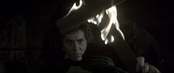 Movie still from “Dracula” (1979), directed by John Badham – A man in a dark room looking at the camera; Medium shot, Low angle