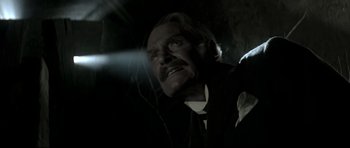 Movie still from “Dracula” (1979), directed by John Badham – A man in a suit and tie looking up at the sky; Close Up shot, Low angle