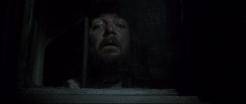 Movie still from “Dracula” (1979), directed by John Badham – A man with a beard looking out of a window; Close Up shot, Low angle