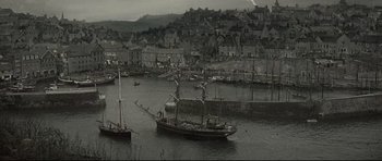 Movie still from “Dracula” (1979), directed by John Badham – A black and white photo of a boat in the water; Extreme Wide shot, High angle