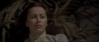 Movie still from “Dracula” (1979), directed by John Badham – A person laying on the ground wearing a dress; Close Up shot, High angle