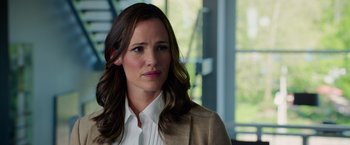 Movie still from “Draft Day” (2014), directed by Ivan Reitman – A person wearing a suit and tie; Close Up shot, Over the shoulder angle