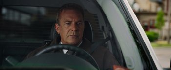 Movie still from “Draft Day” (2014), directed by Ivan Reitman – A person sitting in a car; Close Up shot, Low angle