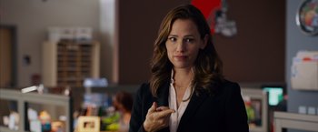 Movie still from “Draft Day” (2014), directed by Ivan Reitman – A woman in a black jacket and a white shirt; Close Up shot, Over the shoulder angle