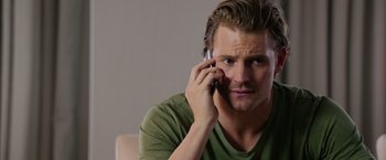 Movie still from “Draft Day” (2014), directed by Ivan Reitman – A person talking on a cell phone; Close Up shot, Over the shoulder angle