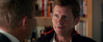 Movie still from “Draft Day” (2014), directed by Ivan Reitman – A person wearing a headset; Close Up shot, Over the shoulder angle