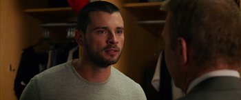 Movie still from “Draft Day” (2014), directed by Ivan Reitman – A person wearing a white shirt; Close Up shot, Over the shoulder angle