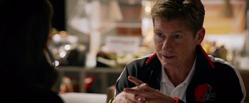 Movie still from “Draft Day” (2014), directed by Ivan Reitman – A person sitting at a table; Close Up shot, Over the shoulder angle