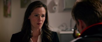 Movie still from “Draft Day” (2014), directed by Ivan Reitman – A person wearing a suit and tie; Close Up shot, Over the shoulder angle