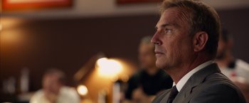 Movie still from “Draft Day” (2014), directed by Ivan Reitman – A person wearing a suit and tie; Close Up shot, Low angle