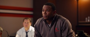 Movie still from “Draft Day” (2014), directed by Ivan Reitman – A person sitting in front of another person; Close Up shot, Over the shoulder angle