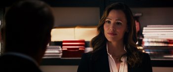 Movie still from “Draft Day” (2014), directed by Ivan Reitman – A woman wearing a suit and a white shirt; Close Up shot, Over the shoulder angle