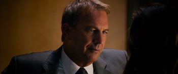 Movie still from “Draft Day” (2014), directed by Ivan Reitman – A person wearing a suit and tie; Close Up shot, Over the shoulder angle