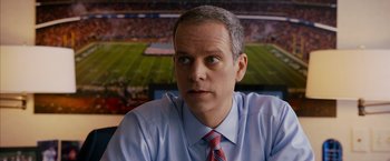 Movie still from “Draft Day” (2014), directed by Ivan Reitman – A person wearing a shirt and a tie; Close Up shot, Low angle