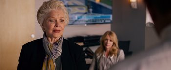 Movie still from “Draft Day” (2014), directed by Ivan Reitman – Two women in front of a television in a room; Close Up shot, Over the shoulder angle
