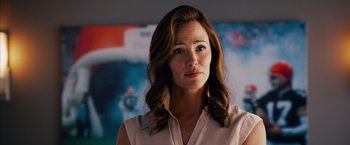 Movie still from “Draft Day” (2014), directed by Ivan Reitman – A person with long hair; Close Up shot, Over the shoulder angle