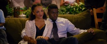 Movie still from “Draft Day” (2014), directed by Ivan Reitman – A man and a woman are sitting on a couch; Medium shot, High angle