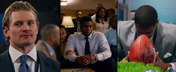 Movie still from “Draft Day” (2014), directed by Ivan Reitman – A group of people sitting in a room; Close Up shot, Over the shoulder angle