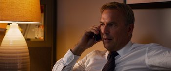 Movie still from “Draft Day” (2014), directed by Ivan Reitman – A person talking on a cell phone; Close Up shot, Low angle