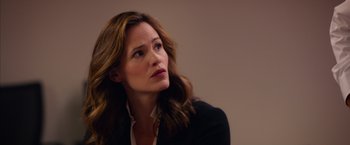 Movie still from “Draft Day” (2014), directed by Ivan Reitman – A person wearing a suit and tie; Close Up shot, Over the shoulder angle