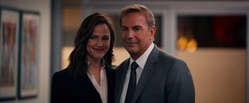 Movie still from “Draft Day” (2014), directed by Ivan Reitman – A man and a woman standing next to each other; Close Up shot, Over the shoulder angle