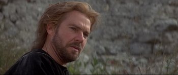 Movie still from “DragonHeart” (1996), directed by Rob Cohen – A person wearing a black shirt; Close Up shot, Low angle