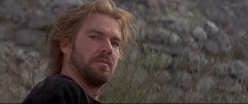 Movie still from “DragonHeart” (1996), directed by Rob Cohen – A person with long blonde hair; Close Up shot, Low angle