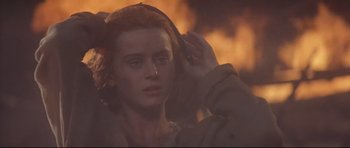 Movie still from “DragonHeart” (1996), directed by Rob Cohen – A young woman with red hair is looking at the camera; Close Up shot, High angle