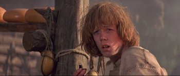 Movie still from “DragonHeart” (1996), directed by Rob Cohen – A young boy holding a piece of wood in his hand; Close Up shot, Low angle