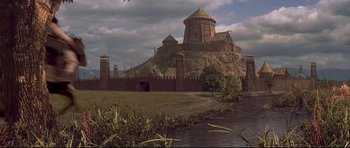 Movie still from “DragonHeart” (1996), directed by Rob Cohen – An old castle with a tower on top of a hill; Extreme Wide shot, High angle
