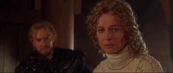 Movie still from “DragonHeart” (1996), directed by Rob Cohen – A woman in a white shirt and a man in a black suit; Close Up shot, Over the shoulder angle