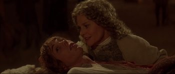 Movie still from “DragonHeart” (1996), directed by Rob Cohen – A man and a woman laying on a bed together; Close Up shot, High angle