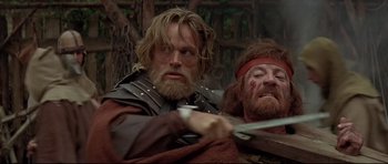 Movie still from “DragonHeart” (1996), directed by Rob Cohen – Two men in medieval garb fighting with swords; Medium shot, Low angle