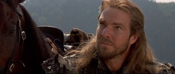 Movie still from “DragonHeart” (1996), directed by Rob Cohen – A person with long hair and a beard; Close Up shot, Low angle