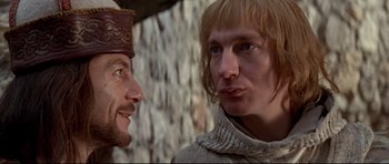 Movie still from “DragonHeart” (1996), directed by Rob Cohen – Two men in medieval garb talking to each other; Close Up shot, Over the shoulder angle