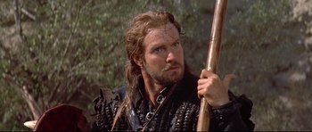 Movie still from “DragonHeart” (1996), directed by Rob Cohen – A person holding a stick; Close Up shot, Low angle