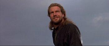 Movie still from “DragonHeart” (1996), directed by Rob Cohen – A person with long hair and a beard; Close Up shot, Low angle