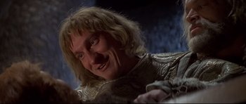 Movie still from “DragonHeart” (1996), directed by Rob Cohen – A person wearing a costume; Close Up shot, Low angle