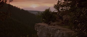 Movie still from “DragonHeart” (1996), directed by Rob Cohen – A view of a sunset from the top of a cliff; Extreme Wide shot, High angle