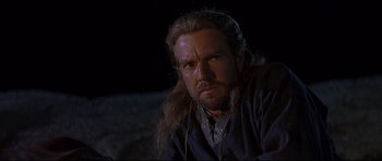 Movie still from “DragonHeart” (1996), directed by Rob Cohen – A person with long hair and a beard; Close Up shot, Low angle